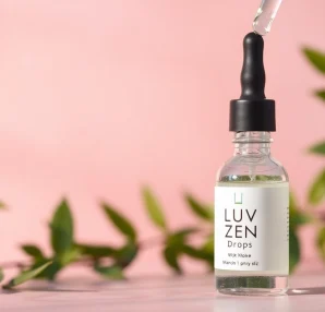 LUV Zen Drops dropper with natural ingredients reflecting calming vibes in a serene setting.