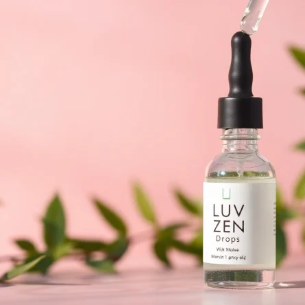 LUV Zen Drops dropper with natural ingredients reflecting calming vibes in a serene setting.