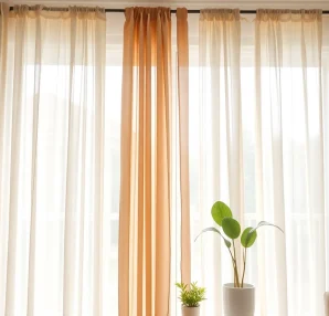 Admire made to measure curtains elegantly styled in a serene interior, enhancing warmth and design.